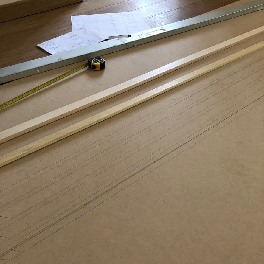 Measurements of wooden slats drawn onto the MDF panel for placement checks