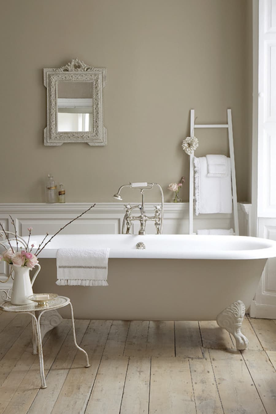 Free standing roll top bath situated in a bathroom that is painted in Little Greene Rolling Fog, a warm beige tone