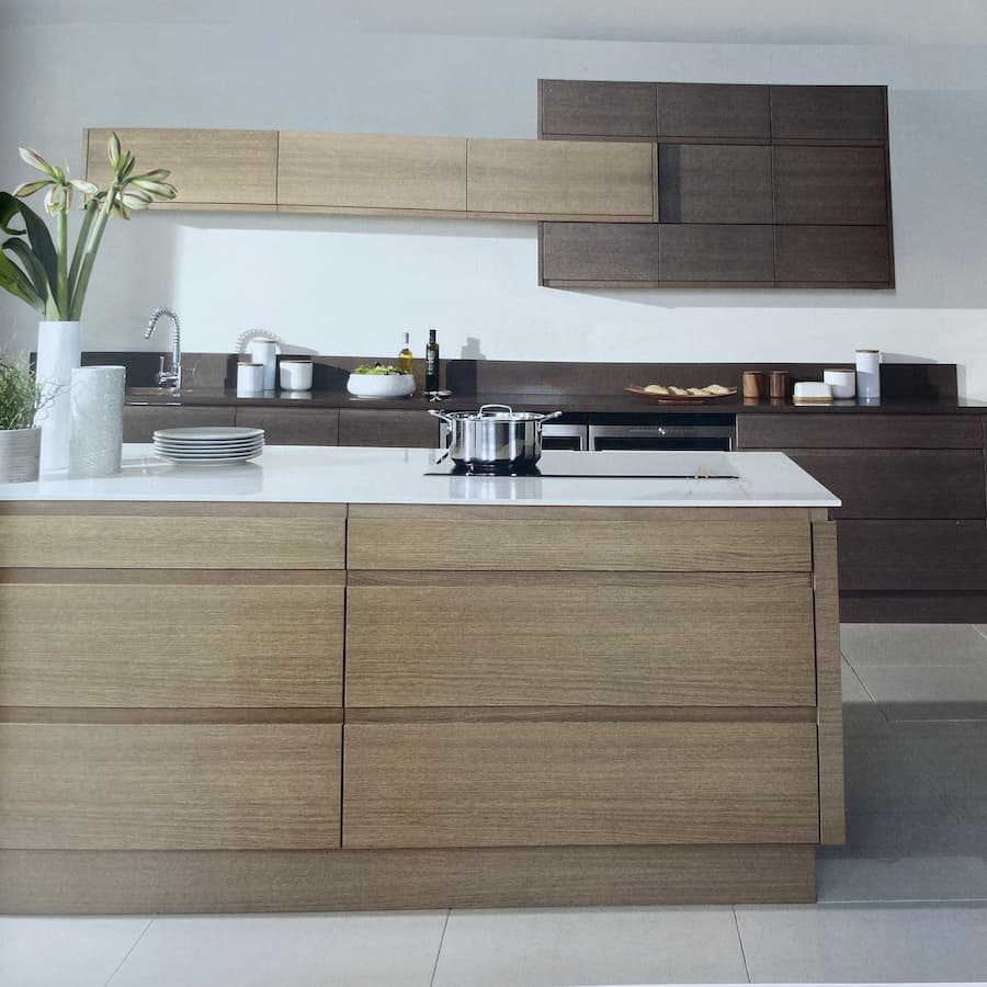 Modern kitchen design with modular interconnecting wall units in oak and walnut and a separate island to the front in oak