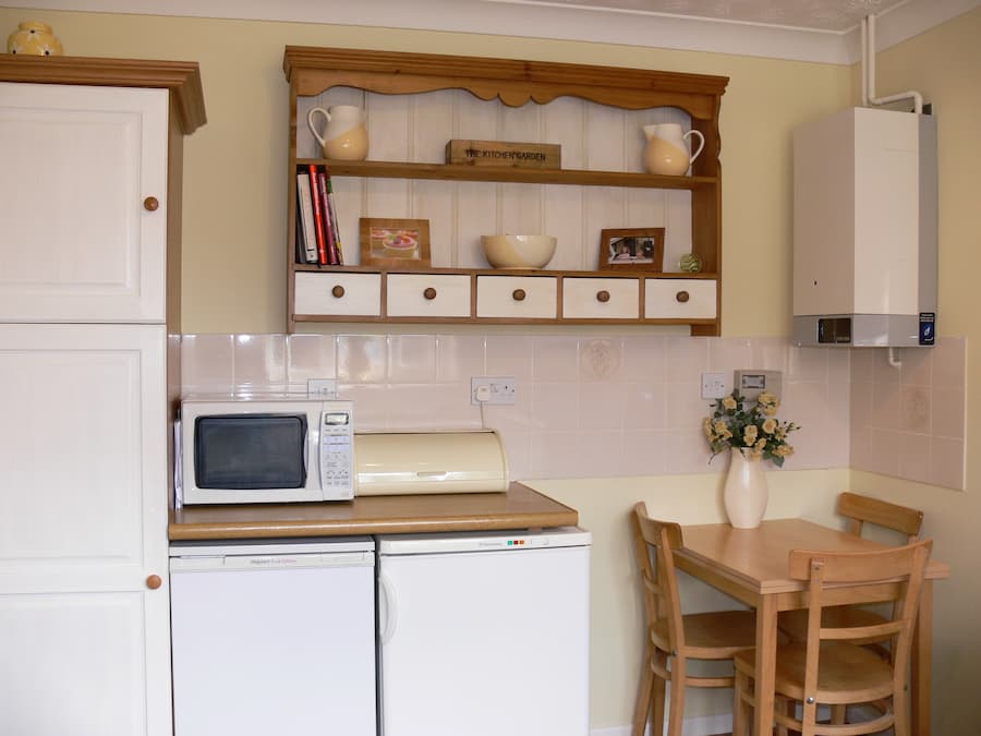 Original kitchen design Outdated white and oak kitchen with welsh dresser shelf on the wall