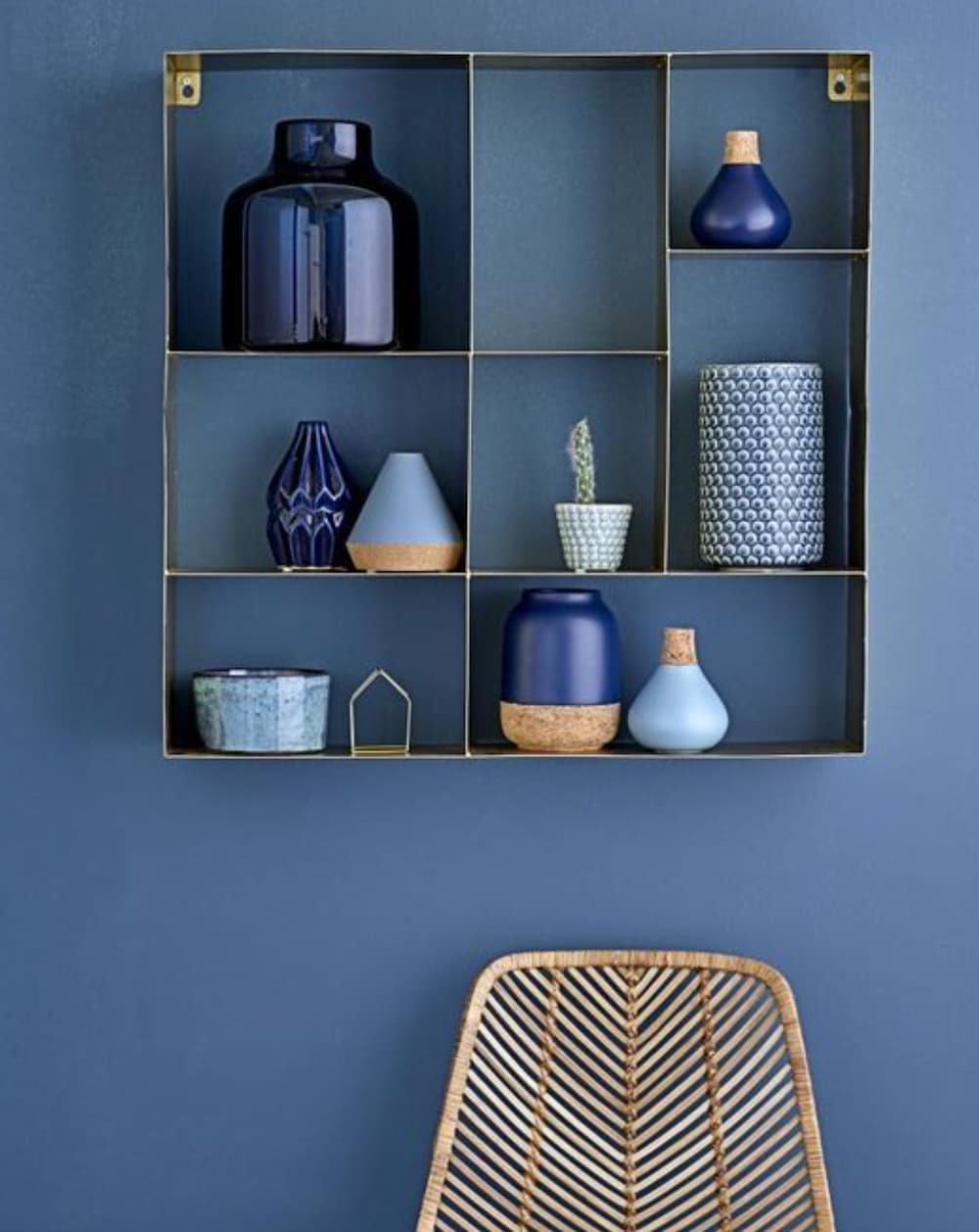 Blue wall with blue accessories positioned on a wall unit