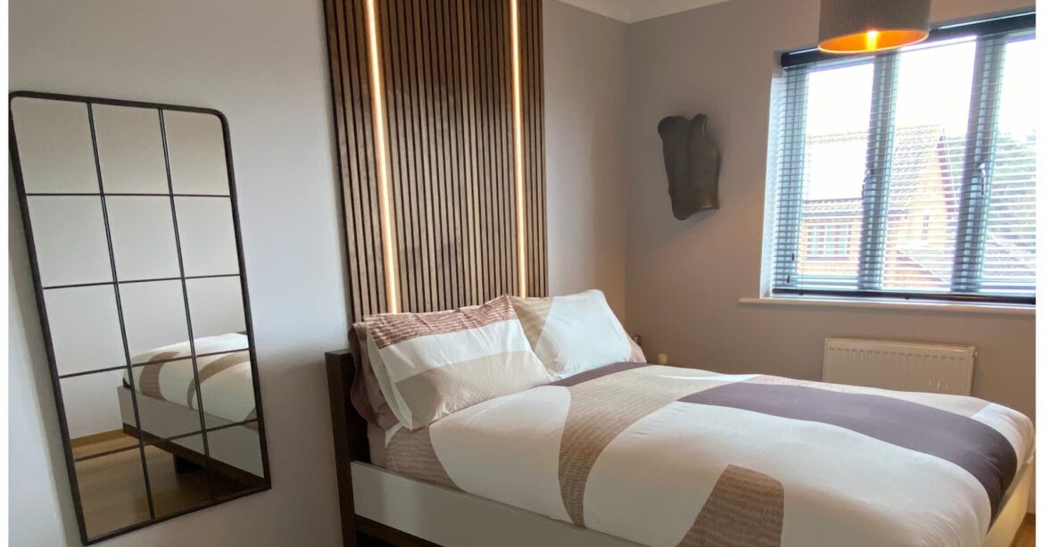 Transforming our master bedroom Bedroom transformation with added wood panelling above the bed and bold geometric bedding in a colour palette of soft, warm neutrals